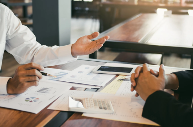 Business managers discussing company finances and planning a transition from umbrella employment to a limited company structure.