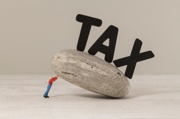 Tax concept illustrating capital gains tax vs corporation tax and their impact on business profits.