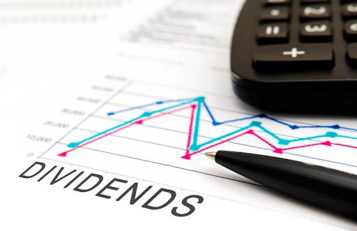 Documents with charts, calculator, and pen illustrating taxation on dividends and financial planning for efficient tax management.
